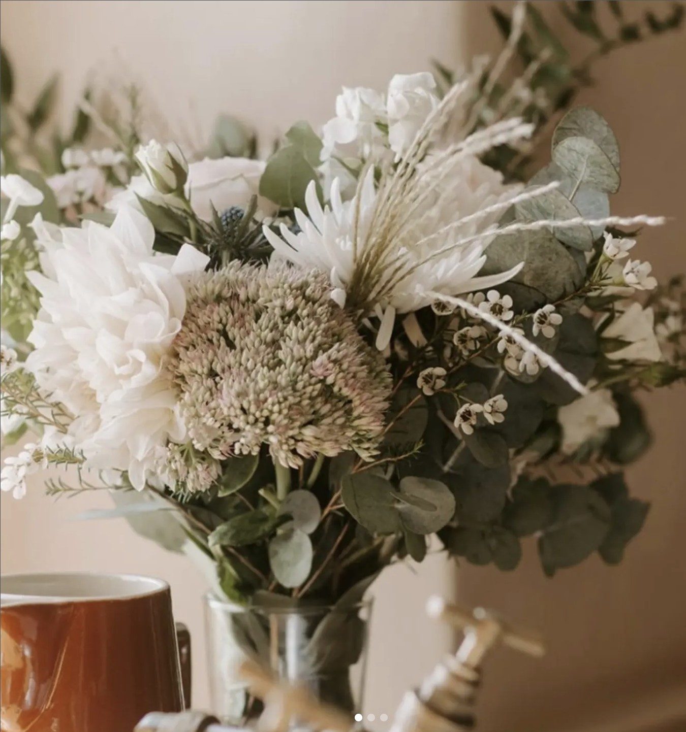 Bridal bouquet of white dahlias, eucalyptus and textured seed heads